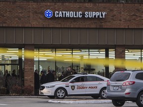 Authorities investigate the scene at a Catholic Supply store where a gunman went into the religious supply store, sexually assaulted at least one woman and shot a woman in the head, Monday, Nov. 19, 2018, in Ballwin, Mo. (Johanna Huckeba/St. Louis Post-Dispatch via AP)
