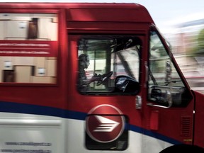 A Canada Post employee drives a mail truck through downtown Halifax on July 6, 2016.