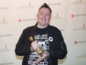 Mike Ward holds up his trophy for best podcast at the gala Olivier awards ceremony in Montreal on December 10, 2017.