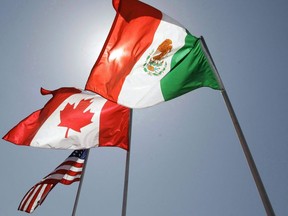 In this April 21, 2008 file photo, national flags representing the United States, Canada, and Mexico fly in the breeze in New Orleans where leaders of the North American Free Trade Agreement met.