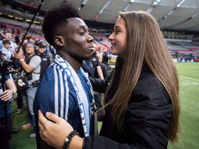 Vancouver Whitecaps midfielder Alphonso Davies, left, receives a hug from Canadian women's national soccer team forward Jordyn Huitema after playing his final match as a member of the MLS team, in Vancouver, on Oct. 28, 2018.