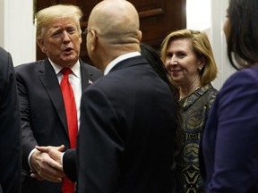 Deputy National Security Adviser Mira Ricardel, right, watches as U.S. President Donald Trump arrives for a Diwali ceremonial lighting of the Diya in the Roosevelt Room of the White House, Tuesday, Nov. 13, 2018, in Washington.