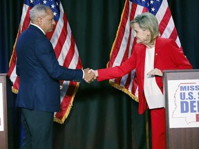 Appointed U.S. Sen. Cindy Hyde-Smith, R-Miss., and Democrat Mike Espy greet each other before their televised Mississippi U.S. Senate debate in Jackson, Miss., Tuesday, Nov. 20, 2018. (AP Photo/Rogelio V. Solis, Pool)