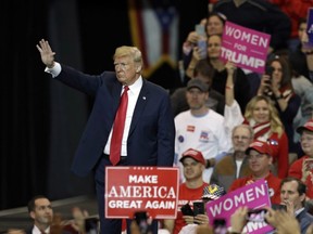 U.S. President Donald Trump waves to supporters after speaking at a campaign rally in Cleveland, Monday, Nov. 5, 2018.