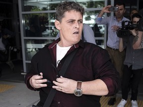 Renae Lawrence charges through a media pack at Newcastle Airport on November 22, 2018 in Newcastle, Australia. (Brook Mitchell/Getty Images)