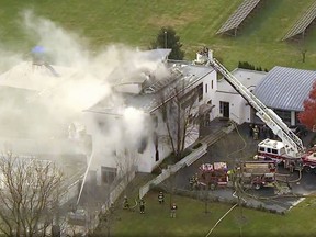 In this image made from a video provided by WABC firefighters battle a fatal fire on Tuesday, Nov. 20, 2018, in Colts Neck, N.J. (WABC via AP)