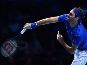 Switzerland's Roger Federer serves against South Africa's Kevin Anderson in their men's singles round-robin match on day five of the ATP World Tour Finals tournament at the O2 Arena in London on Nov. 15, 2018.