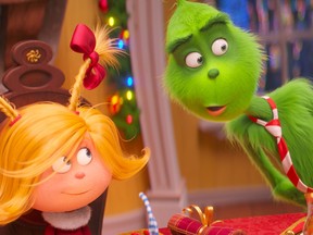 This image released by Universal Pictures shows the characters Cindy-Lou Who, voiced by Cameron Seely, left, and  Grinch, voiced by Benedict Cumberbatch, in a scene from "The Grinch." (Universal Pictures via AP)