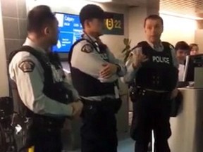 RCMP officers are seen at a Vancouver airport gate Tuesday, Nov. 20, 2018 in this image made from video. (THE CANADIAN PRESS/HO-Caroline Tess)