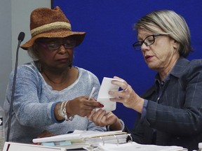Broward Supervisor of Elections Brenda Snipes, left, and judge Betsy Benson of the election canvassing board, listen to arguments, Sunday, Nov. 11, 2018, at the Broward Supervisor of Elections office in Lauderhill, Fla.
