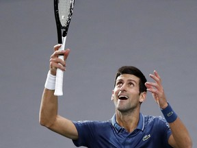 Serbia's Novak Djokovic celebrates after defeating Bosnia and Herzegovina's Damir Dzumhur during their third round match of the Paris Masters tennis tournament at the Bercy Arena in Paris, France, Thursday, Nov. 1, 2018.