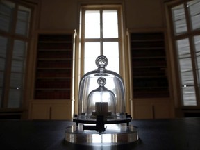 In this photo taken Wednesday, Oct. 17, 2018., a replica of the International Prototype Kilogram is pictured at the International Bureau of Weights and Measures, in Sevres, near Paris. The golf ball-sized metal cylinder at the heart of the world's system for measuring mass is heading into retirement. Gathering this week in Versailles, west of Paris, governments on Friday Nov. 16, 2018, are expected to approve a plan to instead use a scientific formula to define the exact weight of a kilo.