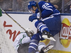 Maple Leafs’ Frederik Gauthier and Dallas Stars’ Julius Honka collide during Thursday night’s game at Scotiabank Arena in Toronto.