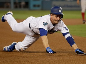 Los Angeles Dodgers' David Freese dives safely into third base for the triple against the Boston Red Sox during the third inning in Game 5 of the World Series baseball game on Sunday, Oct. 28, 2018, in Los Angeles.