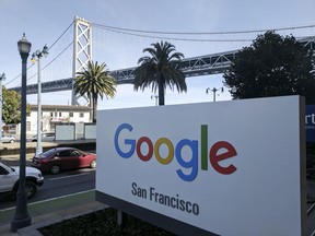 This photo shows signage outside the offices of Google in San Francisco with the San Francisco-Oakland Bay Bridge in the background, Wednesday, Oct. 31, 2018.