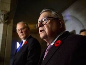 Public Safety Minister Ralph Goodale and Border Security and Organized Crime Minister Bill Blair make a funding announcement on combating gun and gang violence during a press conference on Parliament Hill in Ottawa on Thursday, Nov. 8, 2018.