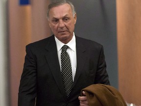 Montreal Canadiens hockey legend Guy Lafleur leaves the courtroom for the lunch break in his lawsuit against the Montreal police and Quebec's attorney-general on Monday, January 12, 2015, in Montreal. (THE CANADIAN PRESS/Ryan Remiorz)