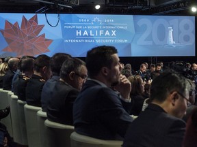 Delegates and reporters attend the Halifax International Security Forum in Halifax on Saturday, Nov. 17, 2018.