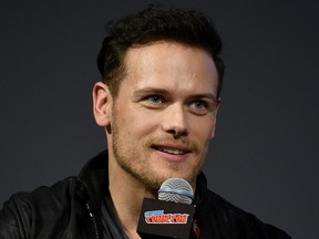 Sam Heughan speaks onstage during the Outlander panel during New York Comic Con at Jacob Javits Center on Oct. 6, 2018 in New York City.