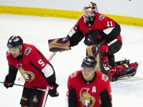 Ottawa Senators goaltender Craig Anderson (41) and teammates Cody Ceci (5) and Mark Borowiecki react after allowing a game-tying goal late in third period NHL action against the Tampa Bay Lightning, in Ottawa, Sunday, Nov. 4, 2018. The Lightning defeated the Senators in overtime.