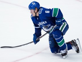 Vancouver Canucks' Brock Boeser reacts as he attempts to get to his feet after being cross-checked in the back by Colorado Avalanche left wing Matt Calvert (11) during the second period of an NHL hockey game in Vancouver, on Friday November 2, 2018.