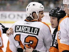 Philadelphia Flyers left wing Daniel Carcillo is restrained by referee Ian Walsh (29) in the first period against the Minnesota Wild during a preseason NHL hockey game in St. Paul, Minn., on September 25, 2010. Daniel Carcillo spoke out on Saturday night about his experience with hazing while a member of the OHL's Sarnia Sting, detailing how he feels Canada's hockey culture needs to change.