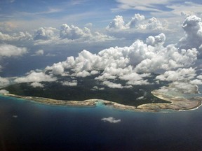 FILE -In this Nov. 14, 2005 file photo, clouds hang over the North Sentinel Island, in India's southeastern Andaman and Nicobar Islands. A rights group that works to protect tribal people has urged Indian authorities to abandon efforts to recover the body of an American man who was thought to be killed by inhabitants of an island where outsiders are effectively forbidden by Indian law.