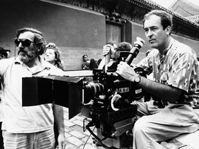 FILE -- In this May 2, 1987 file photo Italian movie director Bernardo Bertolucci, right, checks a scene during the filming go the movie "The Last Emperor", in the Forbidden City of Beijing, China. Bertolucci, who won Oscars with "The Last Emperor" and whose erotic drama "Last Tango in Paris" enthralled and shocked the world, has died at the age of 77. Bertolucci's press office, Punto e Virgola, confirmed the death Monday, Nov. 26, 2018, in an email to The Associated Press.