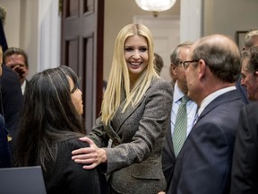 In this Nov. 14, 2018, photo, Ivanka Trump, the daughter of President Donald Trump, centre, greets guests in the Roosevelt Room of the White House in Washington.