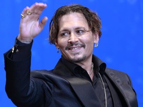 In this Tuesday, June 20, 2017, file photo, U.S. actor Johnny Depp waves for fans upon his arrival at the Japan premiere of his film "Pirates of the Caribbean: Dead Men Tell No Tales" in Tokyo.