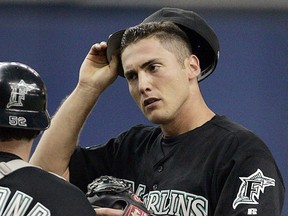 In this July 25, 2004, file photo, Florida Marlins starting pitcher Justin Wayne, right, chats with catcher Mike Redmond in Montreal. (AP Photo/Andre Pichette, File)