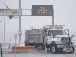 A plow removes snow at an entrance of the Kansas Turnpike near Lawrence, Kan., Sunday, Nov. 25, 2018. The turnpike section of I-70 remains open. I-70 is closed west of Junction City, Kan. The area is under a blizzard warning.