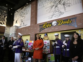 San Francisco Mayor London Breed looks up at the numerous murals on the walls during the opening of Lefty O'Doul's new 20,000 square foot Baseball Ballpark Buffet & Café at Fisherman's Wharf, Tuesday, Nov. 20, 2018, in San Francisco. (AP Photo/Eric Risberg)