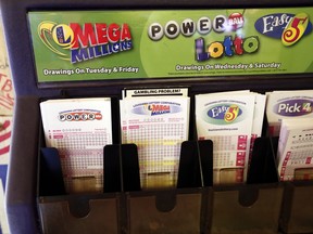 In this Tuesday, Oct. 23, 2018 file photo, lottery forms for Louisiana Mega Millions, Powerball and other lottery games fill the drawer at The World Bar and Grill, in Delta, La., a few miles from the Mississippi-Louisiana state line. (AP Photo/Rogelio V. Solis, File)