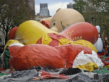 Giant character balloons, including Charlie Brown, are being inflated the night before their appearance in the 92nd Macy's Thanksgiving Day parade, Wednesday Nov. 21, 2018, in New York.