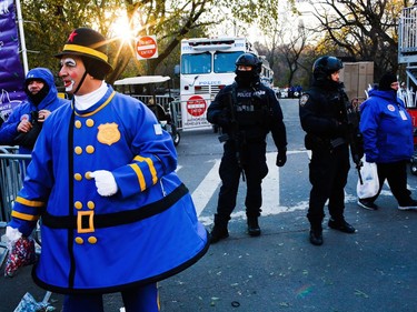 Police take a position along the route before the start of the 92nd annual Macy's Thanksgiving Day Parade in New York, Thursday, Nov. 22, 2018.