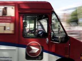 A Canada Post employee drives a mail truck through downtown Halifax on Wednesday, July 6, 2016.