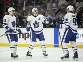 Toronto Maple Leafs centre John Tavares, right, celebrates his goal with defenceman Morgan Rielly, centre, and defenceman Travis Dermott during the first period of an NHL game against the Los Angeles Kings Tuesday, Nov. 13, 2018, in Los Angeles.