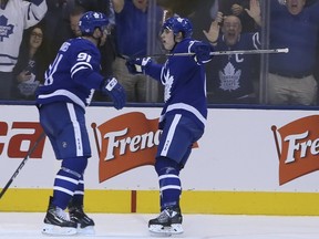 Maple Leafs John Tavares (left) celebrates his goal with teammate Mitch Marner against Columbus on Monday. VERONICA HENRI/TORONTO SUN