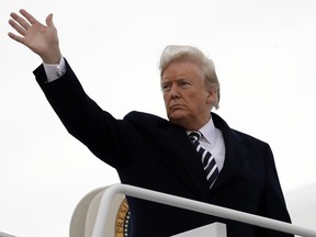 President Donald Trump waves as he boards Air Force One for a campaign rally in Columbia, Mo., Thursday, Nov. 1, 2018, in Andrews Air Force Base, Md.