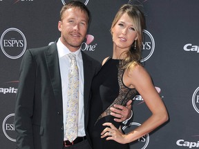 In this July 17, 2013 file photo, Skier Bode Miller, left, and wife Morgan Miller, arrive at the ESPY Awards in Los Angeles.