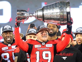 Calgary Stampeders quarterback Bo Levi Mitchell raises the Grey Cup after defeating the Ottawa Redblacks at Commonwealth Stadium in Edmonton on Sunday Nov. 25, 2018.