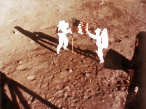 In this NASA handout file photo taken on July 20, 1969, U.S. astronauts Neil Armstrong and "Buzz" Aldrin deploy the American flag on the lunar surface during the Apollo 11 lunar landing mission.