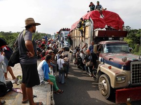 Central American migrants, part of the caravan hoping to reach the U.S. border, get a ride on trucks, in Donaji, Oaxaca state, Mexico, Friday, Nov. 2, 2018. The migrants had already made a grueling 40-mile (65-kilometer) trek from Juchitan, Oaxaca, on Thursday, after they failed to get the bus transportation they had hoped for. But hitching rides allowed them to get to Donaji early, and some headed on to a town even further north, Sayula.