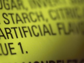 This Thursday, Nov. 8, 2018 photo shows part of an ingredient label, which lists "artificial flavoring," on a packet of candy in New York. In November 2018, the U.S. Food and Drug Administration has decided to give companies two years to purge their products of the six ingredients, described only as "artificial flavors" on packages. The words "artificial flavor" or "natural flavor" refer to any of thousands of ingredients.