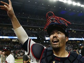 FILE - In this Oct. 7, 2018, file photo, Atlanta Braves catcher Kurt Suzuki celebrates after Game 3 of baseball's National League Division Series against the Los Angeles Dodgers, in Atlanta. Catcher Kurt Suzuki is heading back to the Washington Nationals after agreeing to a $10 million, two-year contract, a deal pending a successful physical.