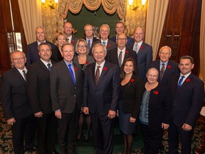 New Brunswick Premier Blaine Higgs, centre, is seen with the members of Executive Council at the New Brunswick Legislature in Fredericton on Friday, Nov. 9, 2018.
