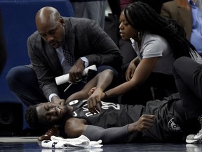 Brooklyn Nets guard Caris LeVert is tended to after an injury during the second quarter of an NBA basketball game against the Minnesota Timberwolves on Monday, Nov. 12, 2018, in Minneapolis.
