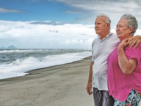 In this Oct. 29, 2018 photo fisherman Gus Hutt is with his wife Sue where he saved saved 18-month-old Malachi Reeve after he had escaped from his parents' tent at Matata Beach, near Whakatane, New Zealand.