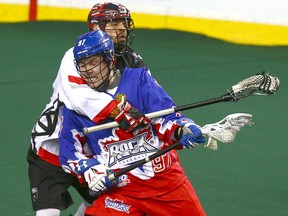 Calgary Roughnecks defender Mike Carnegie ties up Toronto Rock's Reid Reinholdt during National Lacrosse League action  on Saturday, March 24, 2018.